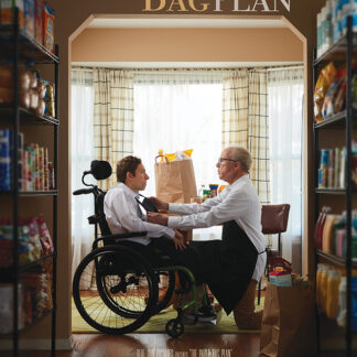 A movie poster for the film “The Paper Bag Plan” features a young man with dark hair in a wheelchair, wearing a white dress shirt. He is being assisted by an older man with glasses, who is dressed in a shirt and apron. They are surrounded by shelves filled with food and positioned in front of a window.